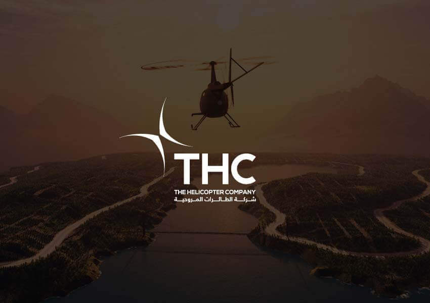 THC - The Helicopter Company logo with a helicopter flying over a scenic landscape