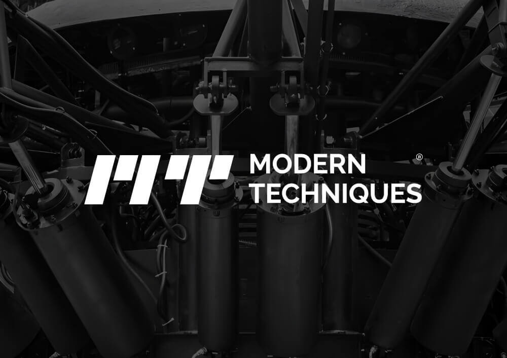 Modern Techniques logo with hydraulic device machinery, created by a top branding company in Saudi Arabia, featured on a digital agency website.